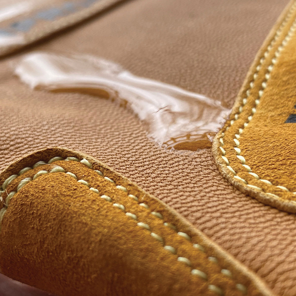 Close-up of a brown leather product with visible stitching