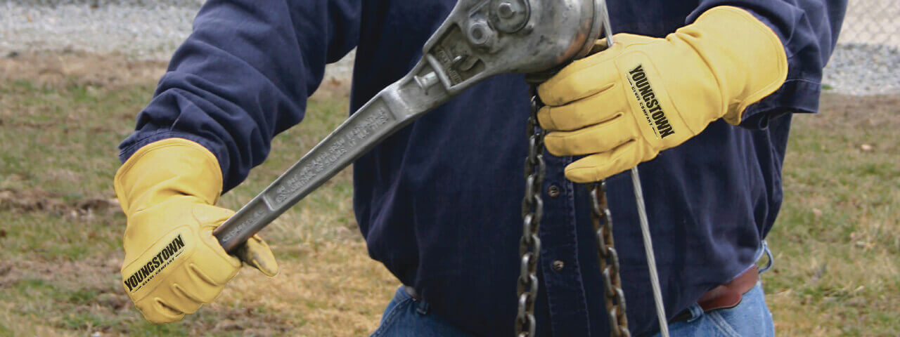 Man wearing Youngstown Arc Rated Gloves working