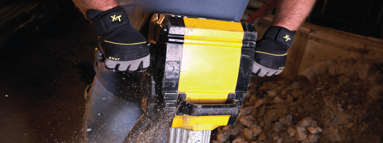 Man wearing Youngstown All Purpose Gloves and jackhammering