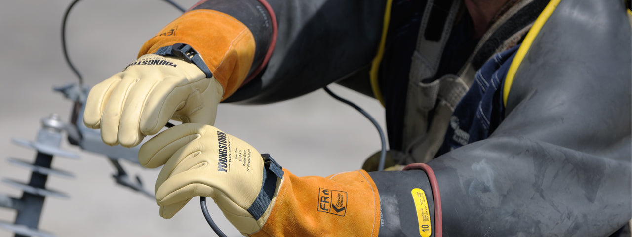 Man wearing Youngstown’s High and Low Voltage Leather Protectors Gloves working on electrical line